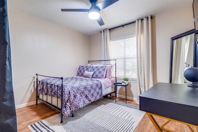 bedroom with ceiling fan and wood-type flooring