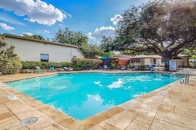 view of swimming pool with a patio area