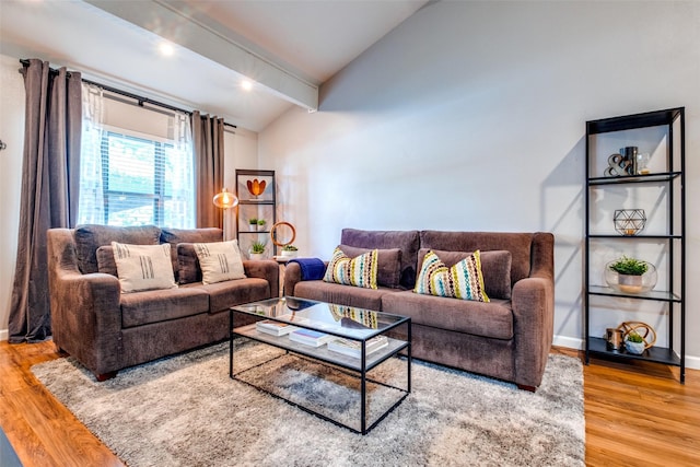 living room featuring hardwood / wood-style flooring and vaulted ceiling with beams