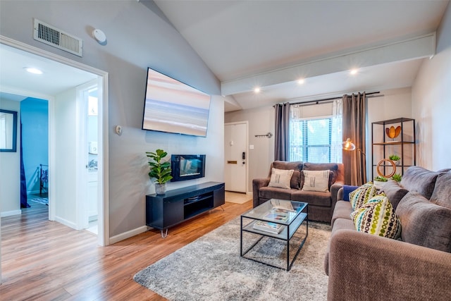 living room with light hardwood / wood-style flooring and lofted ceiling