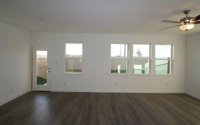 empty room featuring ceiling fan and dark hardwood / wood-style flooring