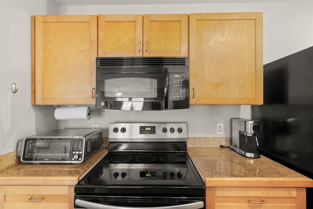 5111 Manett St Unit 103, Dallas, TX 75206 - kitchen featuring black microwave, electric range, light brown cabinetry, and light countertops