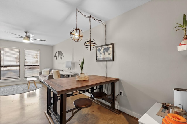 dining area featuring ceiling fan and concrete flooring