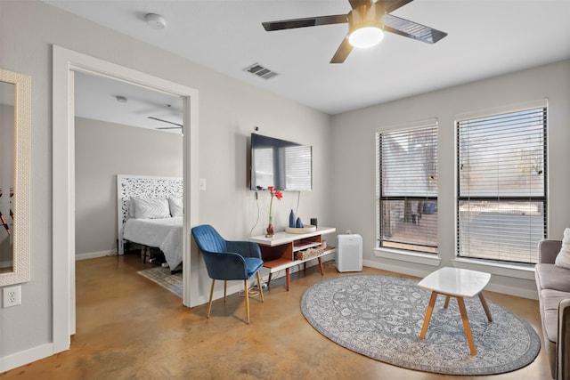 sitting room with concrete floors and ceiling fan