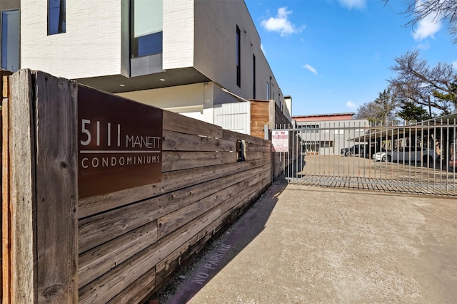 5111 Manett St Unit 103, Dallas, TX 75206 - view of side of property featuring fence and brick siding