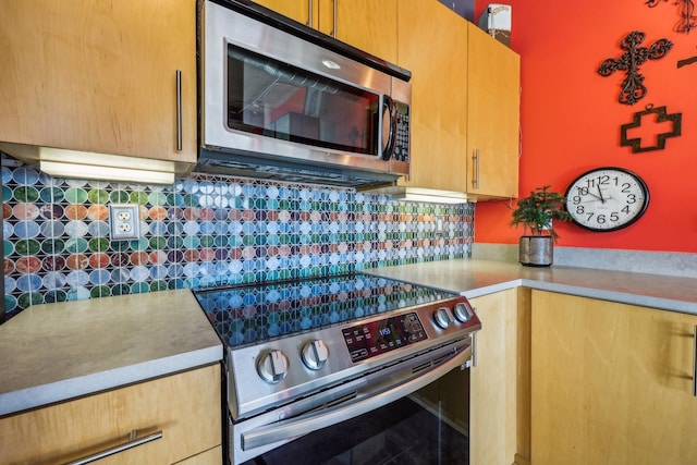 kitchen featuring stainless steel appliances and backsplash