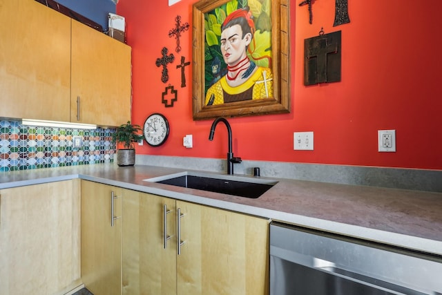 kitchen with sink, stainless steel dishwasher, and tasteful backsplash