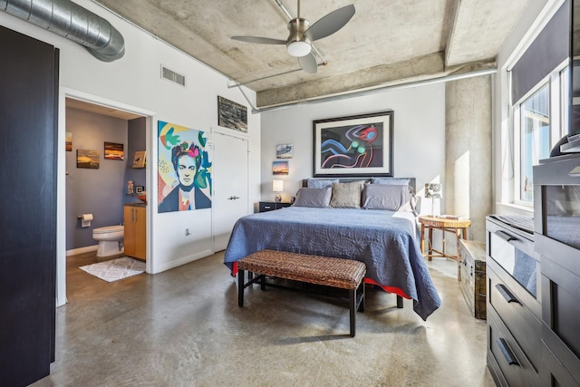 bedroom featuring concrete floors, ensuite bathroom, and ceiling fan