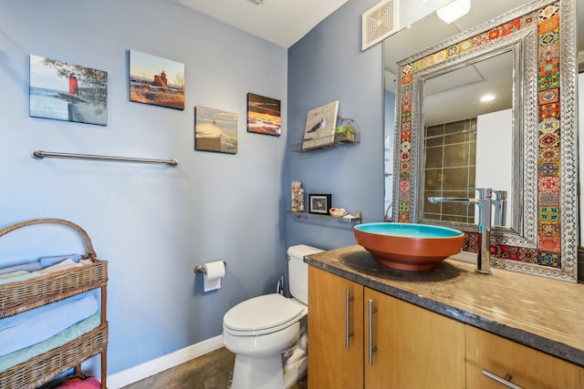 bathroom featuring toilet and vanity