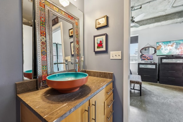 bathroom with concrete floors, vanity, and ceiling fan