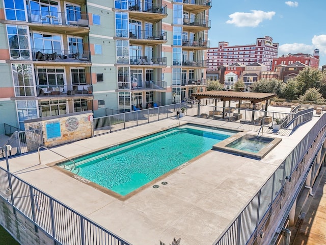 view of swimming pool featuring a pergola, a patio area, and a hot tub