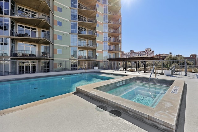 view of swimming pool featuring a community hot tub