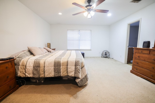 bedroom with ceiling fan and light carpet