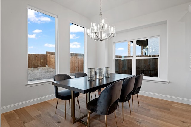 dining room with plenty of natural light and light hardwood / wood-style flooring