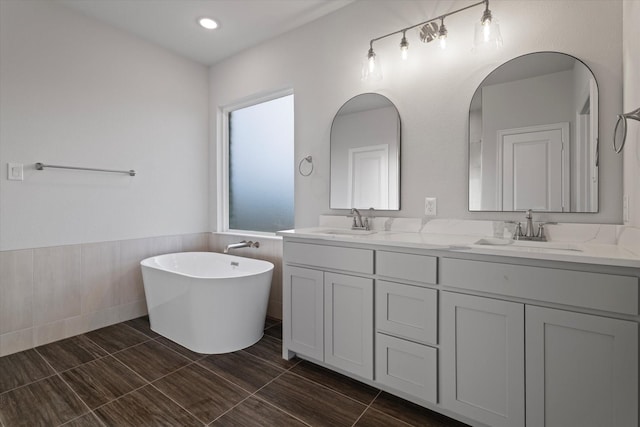 bathroom featuring a tub to relax in and vanity