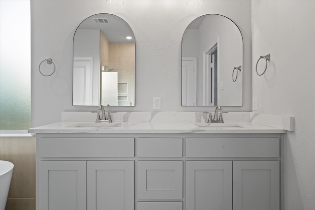 bathroom with vanity and a bathing tub