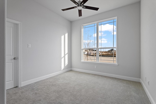 carpeted empty room featuring ceiling fan