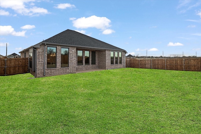 rear view of property with a lawn