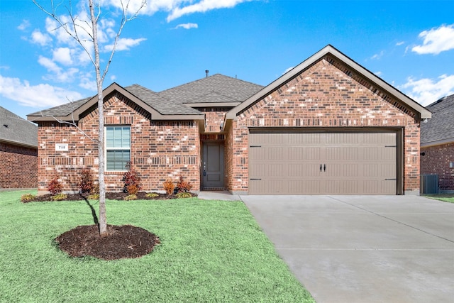 view of property with a garage and a front lawn