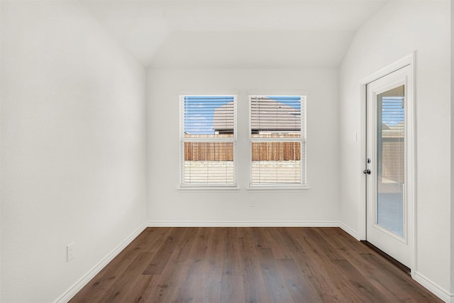 unfurnished room featuring dark hardwood / wood-style floors and lofted ceiling