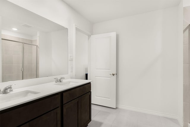 bathroom with vanity, walk in shower, and tile patterned flooring