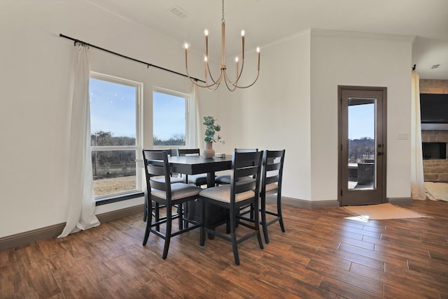 dining area with a chandelier, a healthy amount of sunlight, and crown molding