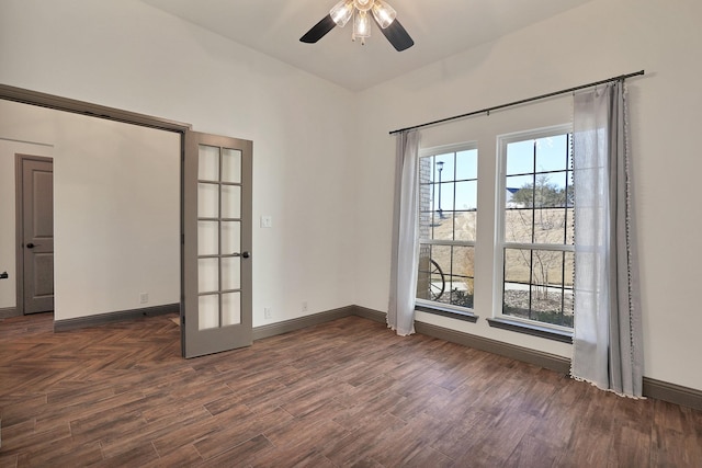 empty room with ceiling fan, dark wood-type flooring, and a wealth of natural light