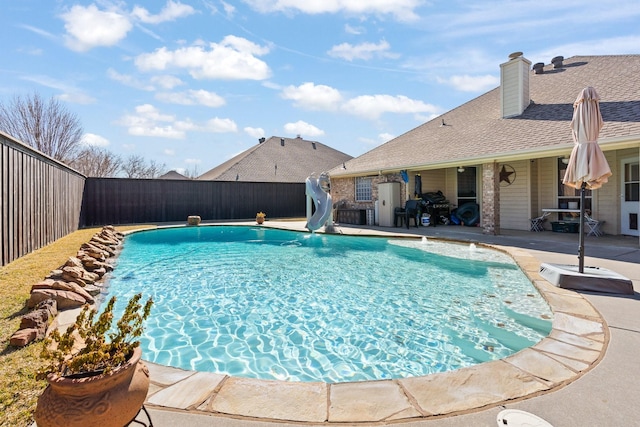 view of swimming pool featuring a patio area and a water slide