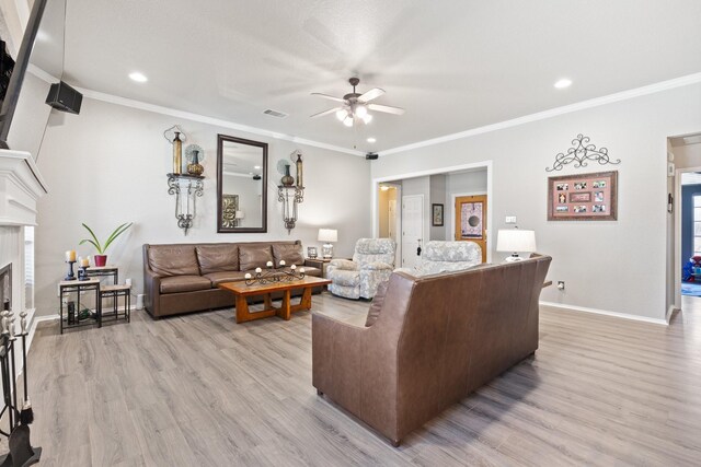 living room featuring ceiling fan, crown molding, and light wood-type flooring