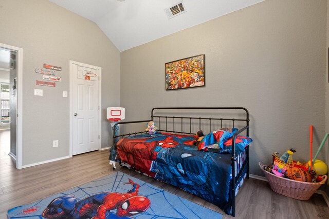 bedroom featuring wood-type flooring and lofted ceiling