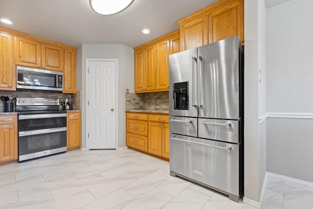 kitchen featuring appliances with stainless steel finishes and decorative backsplash