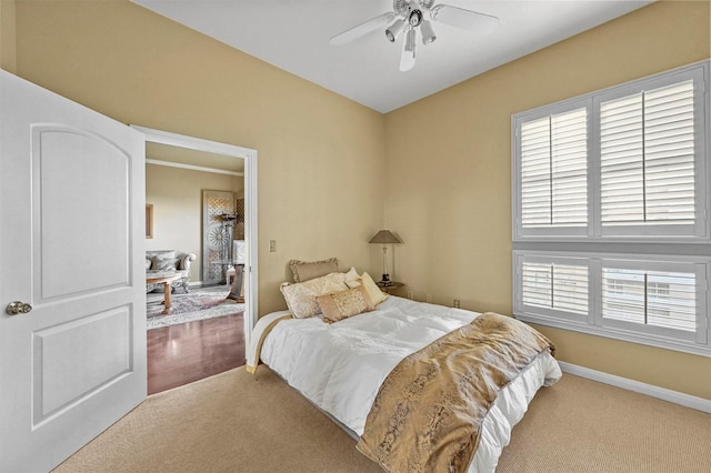 bedroom featuring light carpet, multiple windows, and ceiling fan