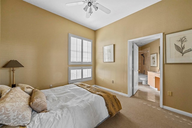 carpeted bedroom with ceiling fan and connected bathroom