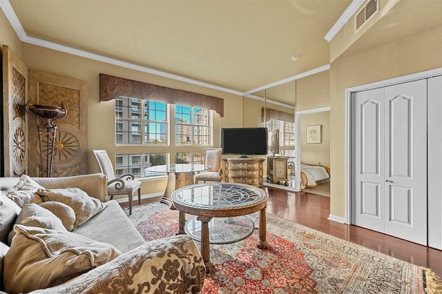 living room with dark wood-type flooring and ornamental molding