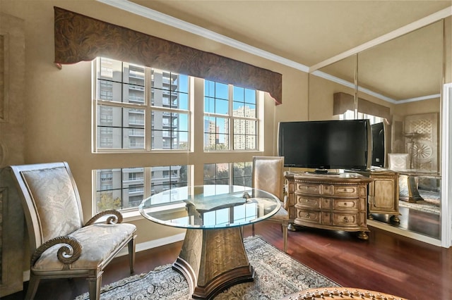 living area featuring hardwood / wood-style flooring and ornamental molding