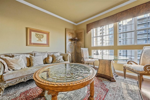 living area with ornamental molding, plenty of natural light, and hardwood / wood-style floors