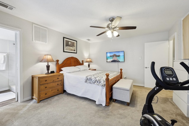 carpeted bedroom with ceiling fan and ensuite bathroom