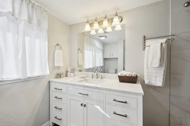 bathroom with toilet and vanity