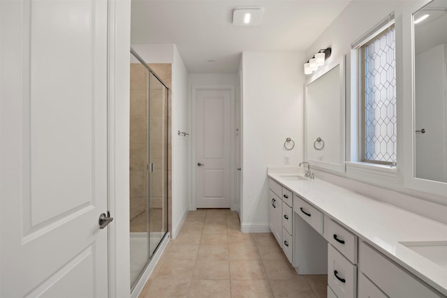 bathroom featuring tile patterned flooring, vanity, and a shower with shower door