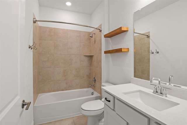 full bathroom featuring tiled shower / bath combo, vanity, tile patterned flooring, and toilet