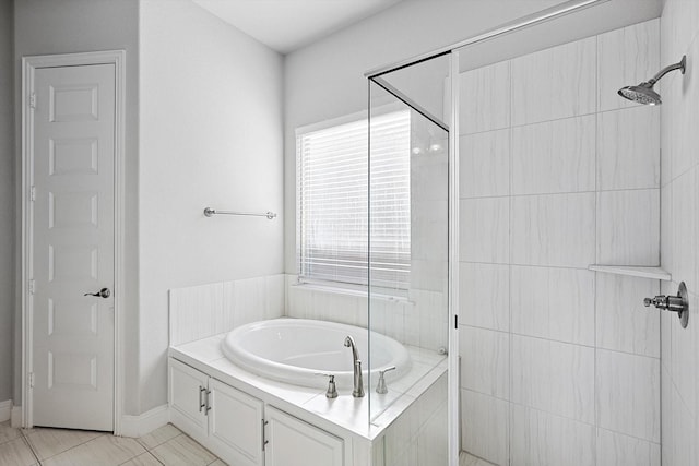 bathroom featuring tile patterned flooring and shower with separate bathtub