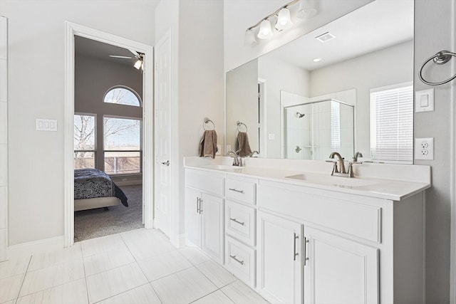 bathroom with vanity, ceiling fan, walk in shower, and tile patterned flooring