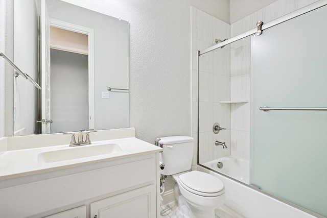 full bathroom featuring vanity, toilet, and bath / shower combo with glass door