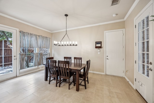 dining area featuring crown molding and a notable chandelier