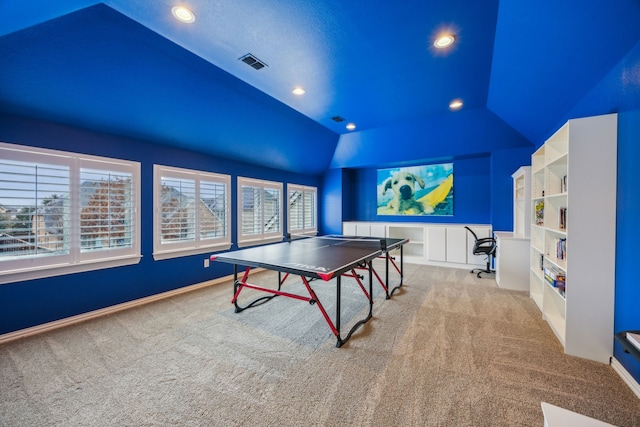 rec room with built in shelves, light carpet, and lofted ceiling