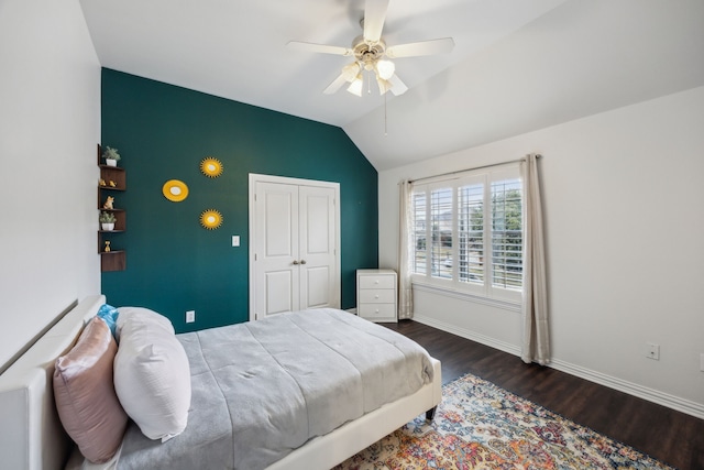 bedroom with ceiling fan, dark wood-type flooring, and lofted ceiling