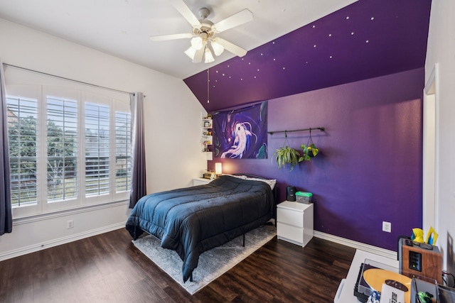 bedroom featuring ceiling fan, multiple windows, and dark hardwood / wood-style floors