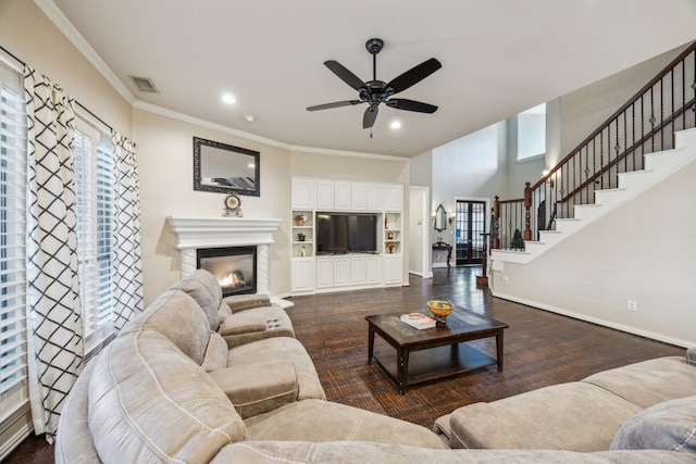 living room with crown molding, dark hardwood / wood-style floors, and ceiling fan