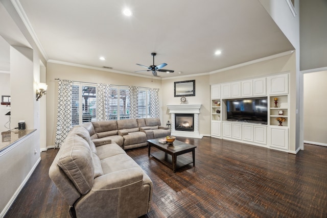 living room with ceiling fan, ornamental molding, and dark wood-type flooring