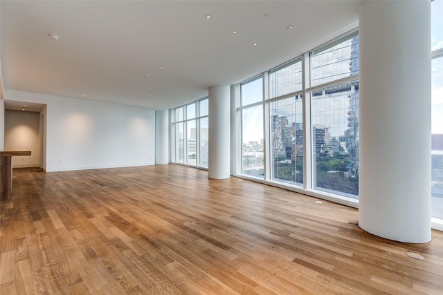 unfurnished living room with light hardwood / wood-style flooring and expansive windows